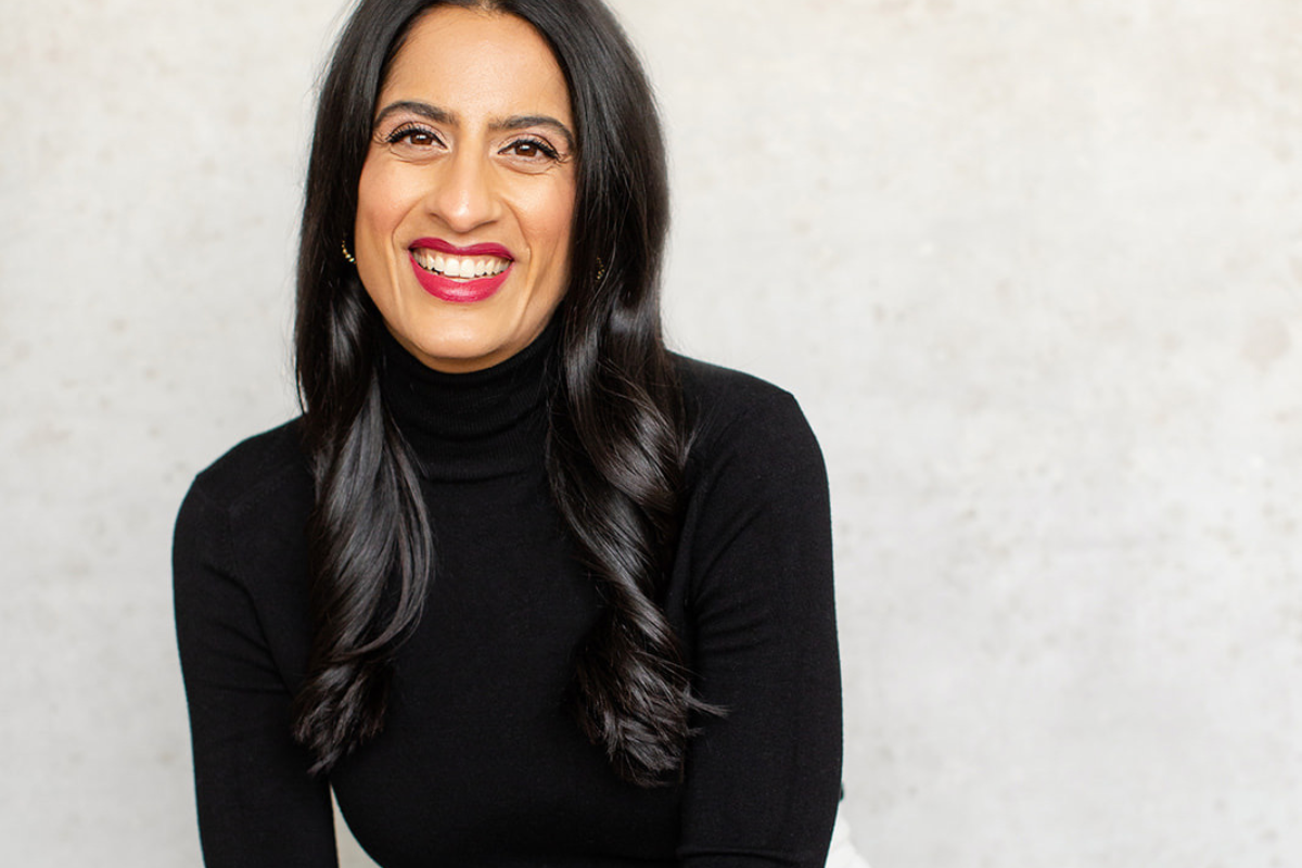 Photo of Dr. Shazma smiling with red lipstick